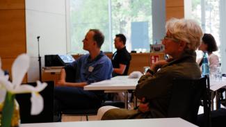 Menschen sitzen im Plenum